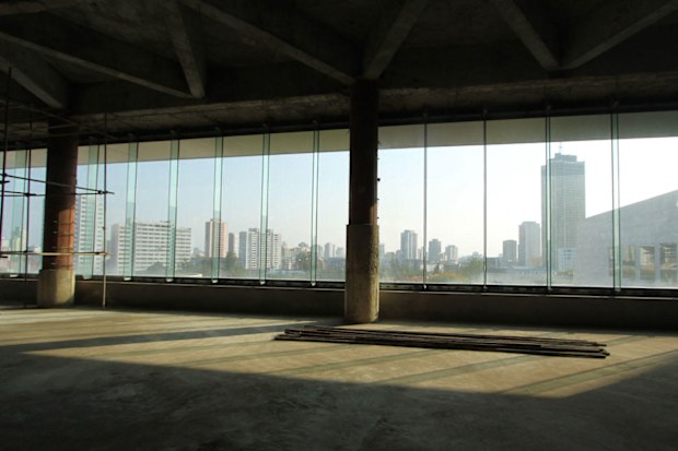 Inside the hotel on the ground floor. The skyline of Pyongyang can be seen through the glass windows.