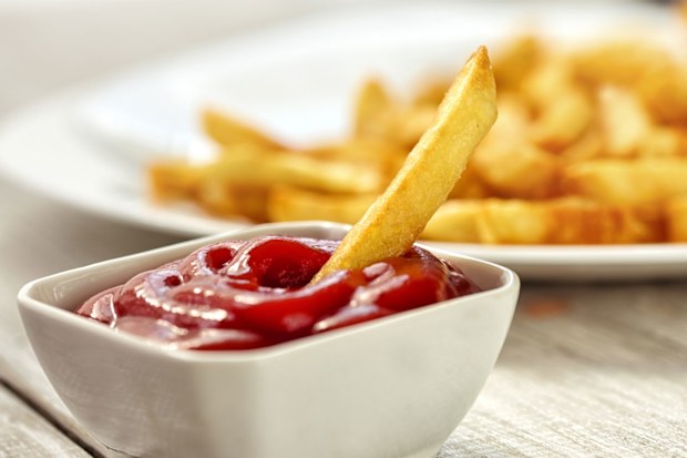 Chip dipped in tomato sauce