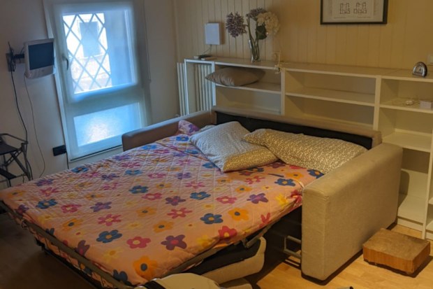Inside a small Airbnb apartment with sofa bed.