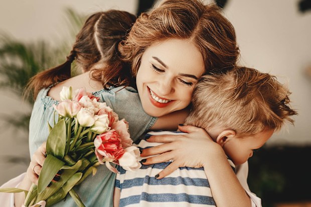 Children give their mother flowers on Mother's Day