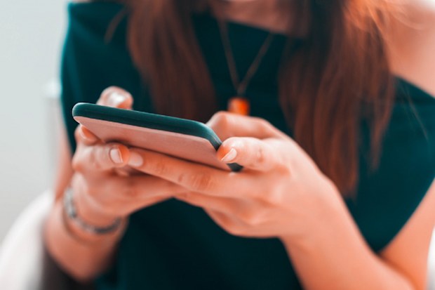 A close-up view of a young woman using her smartphone