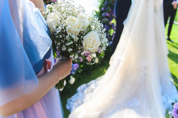 Maid of honour standing next to bride at wedding