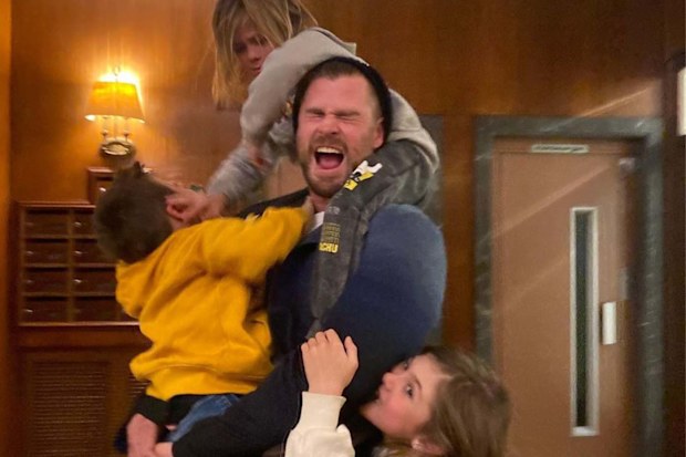 Chris Hemsworth being playfully attacked by his three kids
