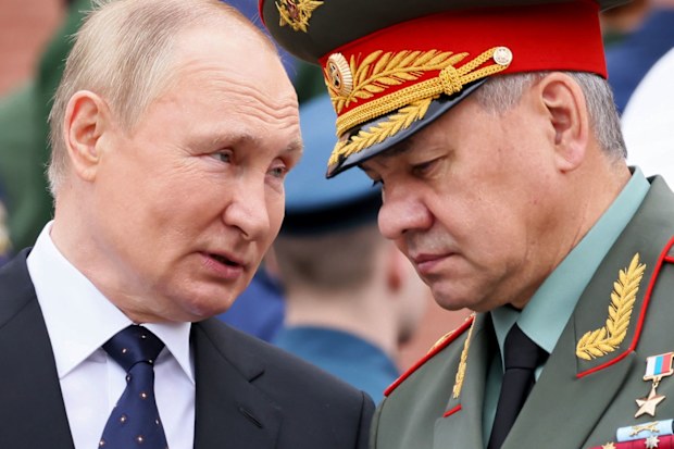 Russian President Vladimir Putin speaks with Russian Defence Minister Sergei Shoigu. 