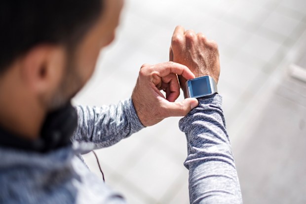 Man checking his Apple Watch