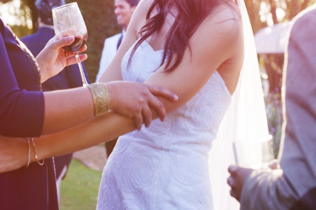 Shot of a happy young bride embracing her guest after getting married
