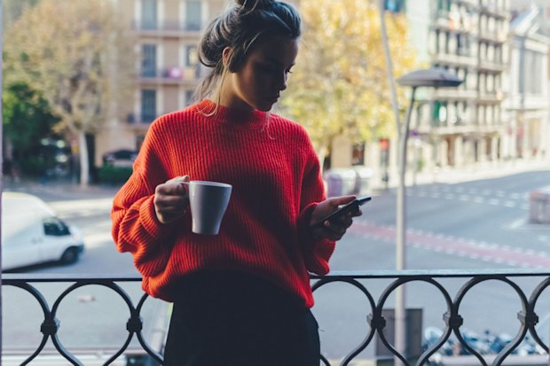 Woman texting at home