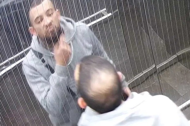 Anthony Karam looking at his reflection in a lift.