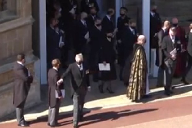 Man waves to car outside St George's Chapel after Prince Philip's funeral