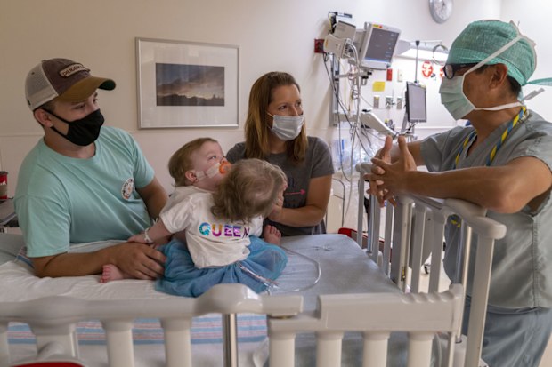 Conjoined twins at home after being separated in surgery.