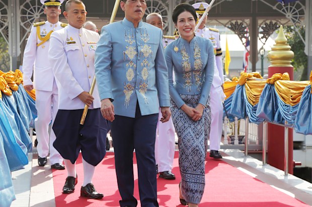 Thai King Maha Vajiralongkorn, center, and his royal noble consort Sineenat Wongvajirabhakdi, right, arrive at the Wasukri pier during a merit-making ceremony for her 36th birthday in Bangkok, Thailand, on Tuesday, Jan. 26, 2021. Thai royal noble consort Sineenat was born on Jan. 26, 1985 .(AP Photo)