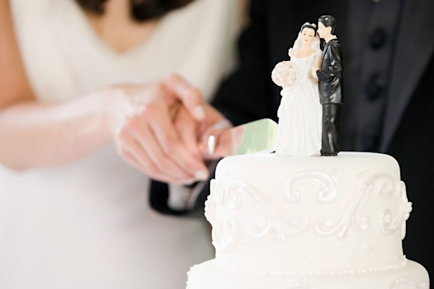 Couple cutting wedding cake