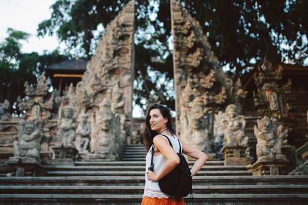 Young woman on holiday in Bali, visiting temples