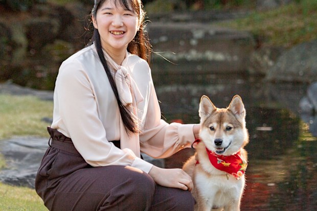 Japan's Princess Aiko, daughter of Emperor Naruhito and Empress Masako, poses for a photograph with her pet dog Yuri at her residence in Tokyo on Nov. 22, 2020. Princess Aiko celebrates her 19th birthday on Tuesday, Dec. 1, 2020