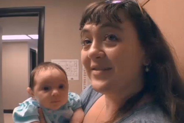 Woman with baby girl - gave birth after husband died