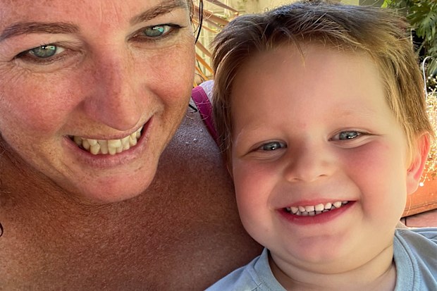 Mum and son smiling into the camera.