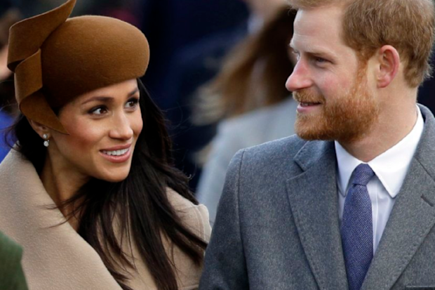 Meghan and Harry waling smiling