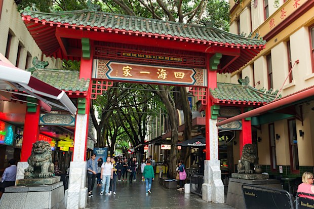Sydney, Australia - November 5, 2015: People walking passed the gates of Sydney's Chinatown.