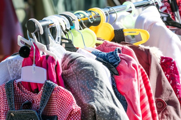 A rack full of second-hand children's clothing