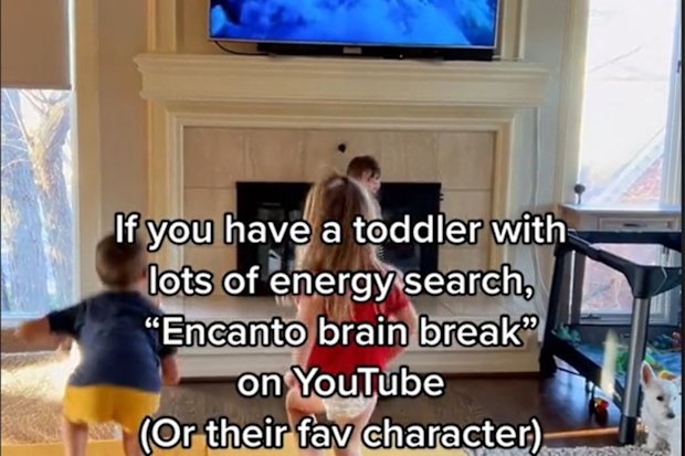 Kids running on a mat in front of the TV.