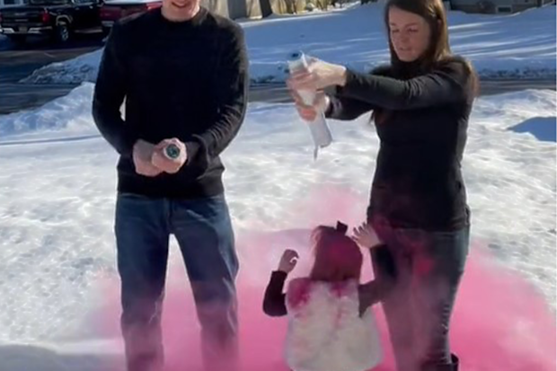 Little girl engulfed in pink smoke after a coloured smoke cannon was released the wrong way, onto her head.