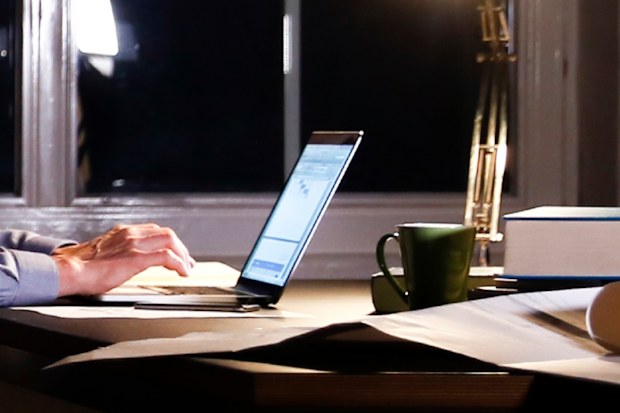 Man using computer in office at night