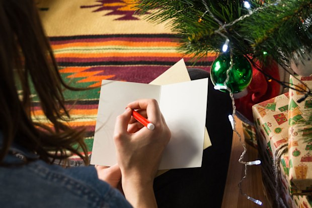 Woman writing Christmas cards