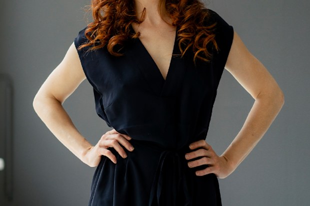 Woman standing with her hands on her hips.