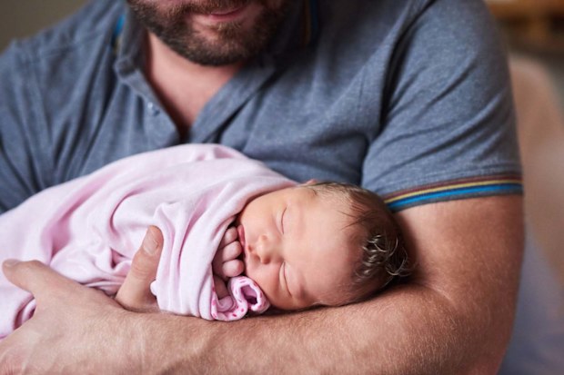 Father holding newborn baby girl