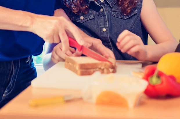 Mother and child cutting sandwich