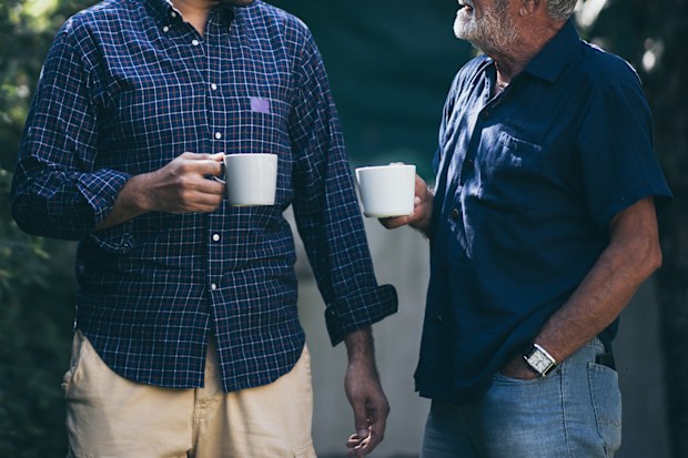 Father and son with coffee cup