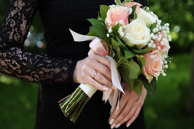 Goth bride holding flowers