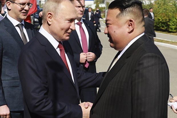 Russian President Vladimir Putin and North Korea's leader Kim Jong-un shake hands during their meeting at the Vostochny cosmodrome.
