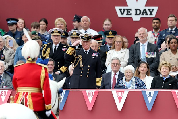King Charles III salutes as Ukrainian Soldiers march-by during the military procession to mark the 80th anniversary of VE Day on May 05, 2025 in London, England. 