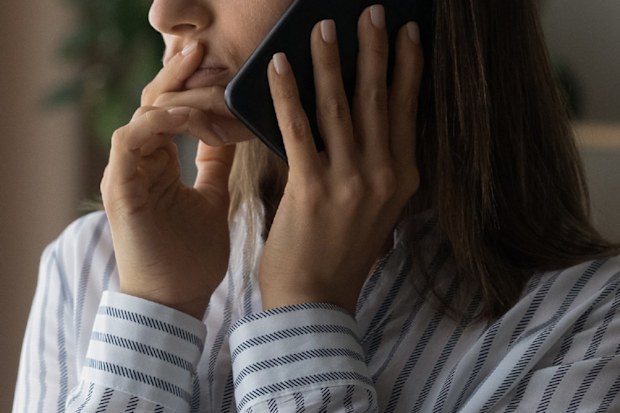 Confused woman using phone