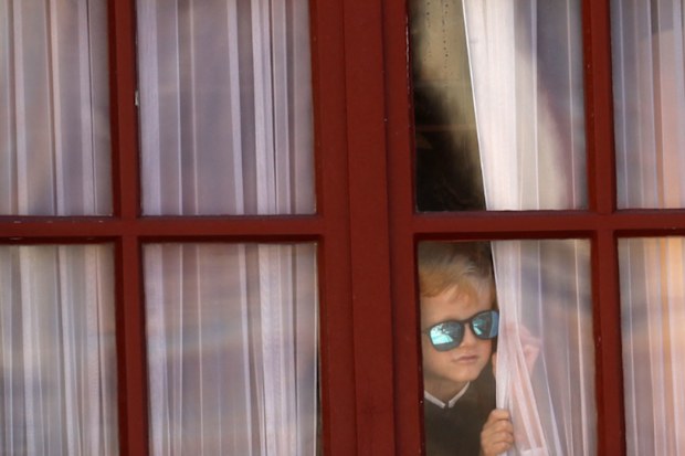 The cheeky royal spied on the proceedings from above through a window overlooking the courtyard. 