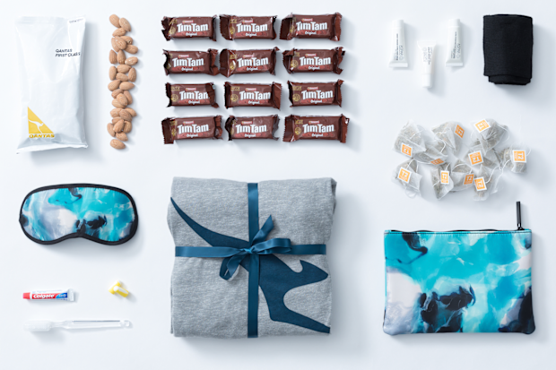 Qantas care package featuring pjamas, amenities and inflight snacks