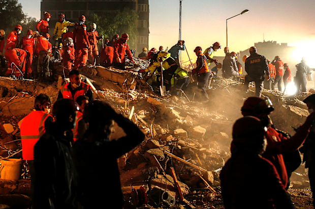 Members of rescue services search for survivors in the debris of a collapsed building in Izmir, Turkey, Monday, Nov. 2, 2020. In scenes that captured Turkey's emotional roller-coaster after a deadly earthquake, rescue workers dug two girls out alive Monday from the rubble of collapsed apartment buildings three days after the region was jolted by quake that killed scores of people. Close to a thousand people were injured.