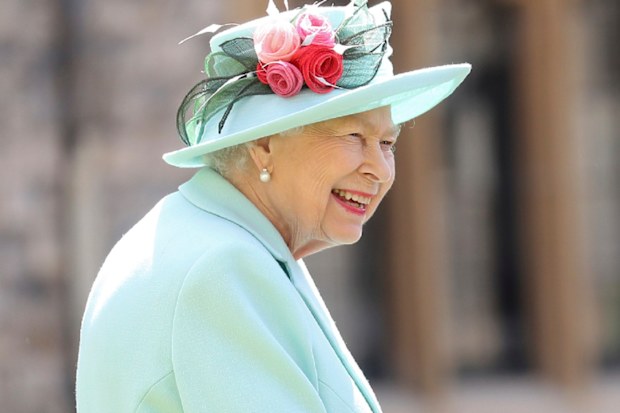 Britain's Queen Elizabeth smiles after awarding Captain Sir Thomas Moore his knighthood during a ceremony at Windsor Castle.