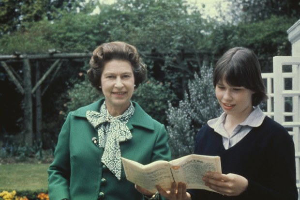 Queen Elizabeth II, wearing a green jacket with a green-and-white scarf, with her niece Sarah Armstrong-Jones, who holds an document in her hands, United Kingdom, circa 1980.