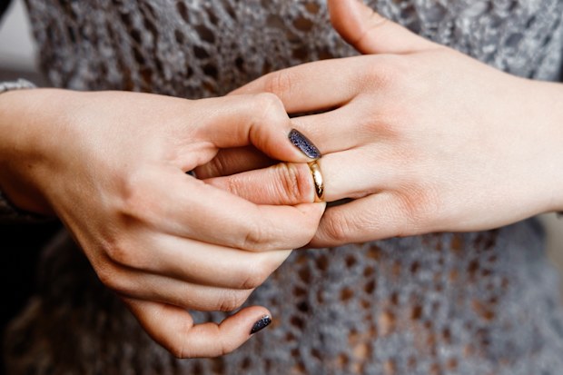 Woman taking off her wedding ring