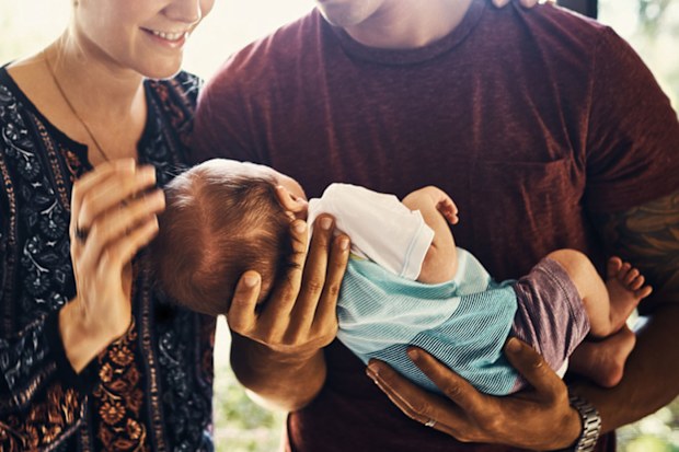 Man and women holding baby