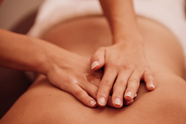 woman getting a back massage at a spa 