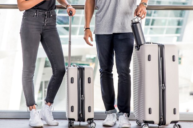 Couple luggage airport iphones