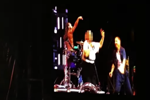 A Macklemore fan has been arrested after what should have been a dream experience on-stage with the Thrift Shop singer.