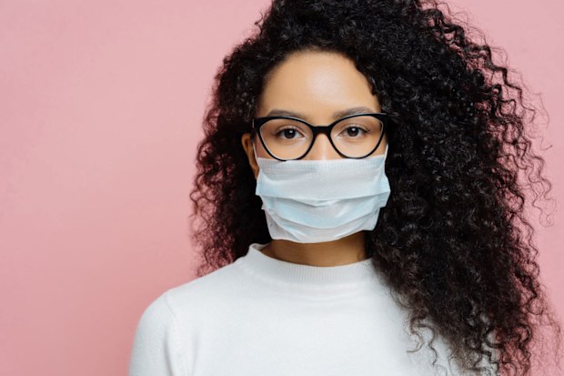 Young woman wearing a face mask and glasses