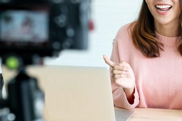 Young woman talking on camera