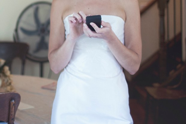 Bride sending text messages ahead of wedding