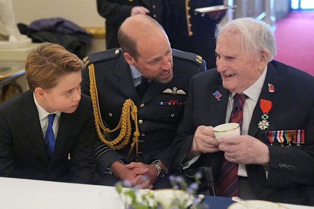 Prince George of Wales and Prince William, Prince of Wales speak with Second World War veterans at a tea party in Buckingham Palace on May 5, 2025 in London, England. 