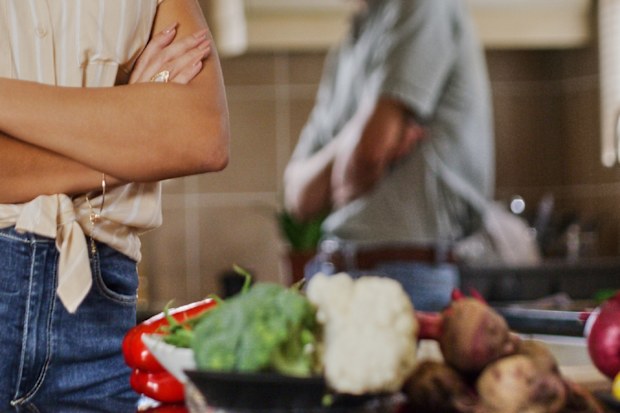Couple fighting in kitchen food on bench